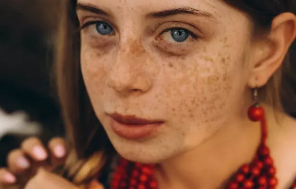 Girl with a freckled face and blue eyes